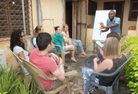 Volunteer Language Courses A group of volunteers in Togo attend a Ewe language class to improve their skills in this local language.
