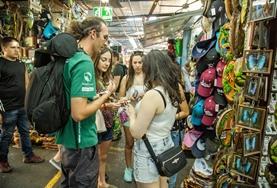 Volunteer Language Courses Volunteers practise their Spanish language skills while speaking to local vendors at a market in Costa Rica.