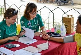 Volunteer Philippines Public Health volunteers takes measurements like blood pressure and blood sugar levels during a medical outreach in the Philippines.