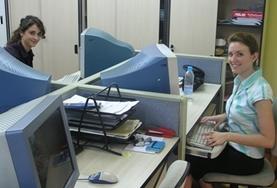 Volunteer Business Two Business interns work at their desks at their placement in China.