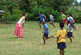 Volunteer Fiji A childcare volunteer plays a game with local children in Fiji to help with improving their motor skills.