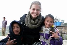 Volunteer Care A childcare volunteer works closely with two children at a care centre in Nepal.