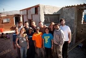 Volunteer Culture & Community Volunteers and local people from a South African township work on building houses to benefit the community.
