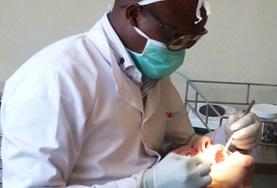 Volunteer Medical Electives A local dentist in Kenya performs a procedure on a patient as a Dentistry Elective intern observes and assists.
