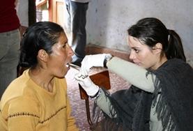 Volunteer Medical Electives A dentistry student volunteering in Peru examines a patient's teeth as part of her elective work.