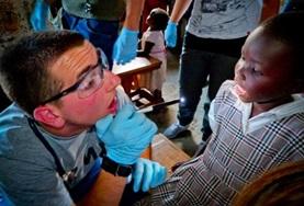 Volunteer Medical Electives A medicine student volunteering in Kenya works at a community outreach to earn credit for his elective.