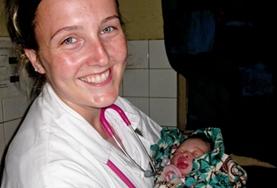 Volunteer Togo A Midwifery Elective intern holds a newborn baby in the maternity department of a local hospital in Togo.