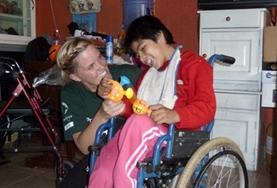 Volunteer Bolivia A Nursing Elective intern works closely with a disabled child at her volunteer placement in Bolivia.
