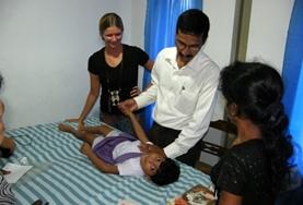 Volunteer Sri Lanka An intern doing her Physiotherapy Elective in Sri Lanka observes as a local physiotherapist demonstrates a treatment technique.