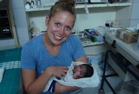 Volunteer Midwifery An intern doing her Midwifery Elective in a developing country holds a newborn baby.
