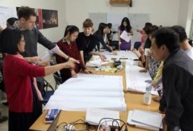 Volunteer Vietnam International Development volunteers discuss a fundraising event with staff from a local NGO in Vietnam.