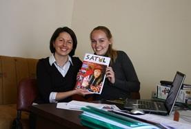 Volunteer Journalism A local journalist and a Journalism intern in Romania hold the magazine they have been working on together.