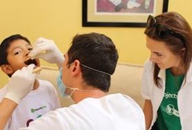 Volunteer Medicine & Healthcare A Dentistry intern observes as a dentist performs a check-up on a boy in Guadalajara, Mexico.