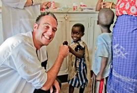 Volunteer Medicine & Healthcare A Dentistry intern gives a child a high-five after a successful dentisty check-up at a hospital in Tanzania.