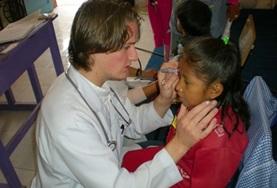 Volunteer Medicine & Healthcare A Medicine volunteer performs a healthcare check-up on a girl in Bolivia, South America.