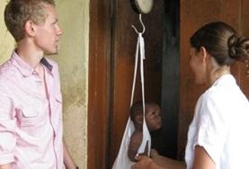 Volunteer Medicine & Healthcare Medicine interns weigh a baby at our volunteer placement hospital in Ghana.