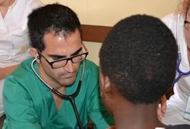 Volunteer Medicine & Healthcare A Medicine volunteer checks a child's heart rate during a healthcare screening outreach in Kenya.