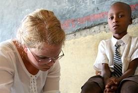 Volunteer Medicine & Healthcare A Medicine intern helps with cleaning and dressing a child's wound at a healthcare outreach in Kenya.