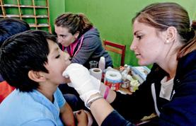 Volunteer Medicine & Healthcare A Medicine intern examines a child during a medical outreach in Cusco, Peru.