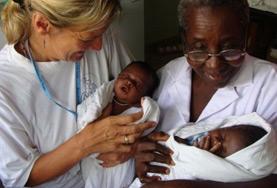 Volunteer Medicine & Healthcare A Midwifery volunteer and a medical staff member hold two babies delivered in the maternity department of a hospital in Ghana.