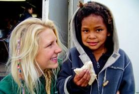 Volunteer Medicine & Healthcare A Nutrition volunteer doing her internship in South Africa talks to a child about the importance of healthy eating.