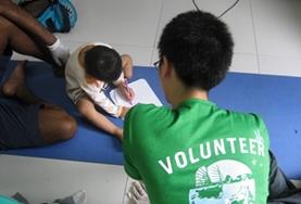 Volunteer Philippines Under the guidance of a qualified occupational therapist, a medicine volunteer in the Philippines administers a test to determine the tasks that a disabled child is struggling with.