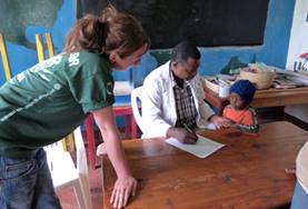 Volunteer Medicine & Healthcare A local occupational therapist demonstrates an assessment technique to a Medical intern in Tanzania.