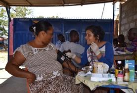 Volunteer Ghana A Pharmacy intern volunteering at an outreach in Ghana helps with distributing medicine to local patients.