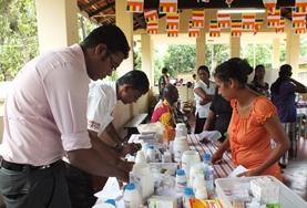 Volunteer Sri Lanka A Pharmacy intern shadows a local pharmacist as he dispenses medicine to local people in Sri Lanka.