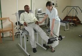 Volunteer Medicine & Healthcare A Physiotherapy intern in Ghana uses a weights machine to exercise a patient's leg muscles at a local hospital.