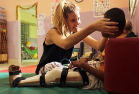 Volunteer Medicine & Healthcare A Physiotherapy intern at our volunteer placement in the Philippines works with a disabled boy on improving his mobility.