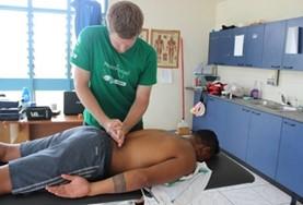 Volunteer Medicine & Healthcare A Physiotherapy intern treats a rugby player in Samoa who has injured himself during a match.