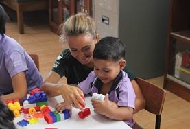 Volunteer Occupational Therapy An Occupational Therapy volunteer works closely with a local child to improve his daily functioning during her medical internship.