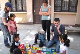 Volunteer Care Professional social workers volunteering in Bolivia work through a therapeutic activity with local children.