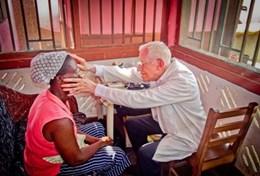 Volunteer Medicine & Healthcare A professional medical doctor performs health checks during a volunteer screening outreach at our placement in Ghana.