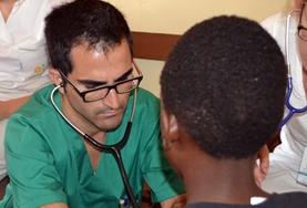 Volunteer Medicine & Healthcare A qualified medical Doctor performs healthcare screening checks on a child during a volunteer outreach in Jamaica.