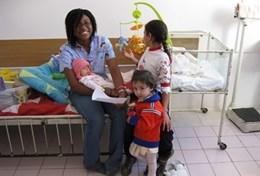 Volunteer Medicine & Healthcare A professional massage therapist spends time with the children at her volunteer placement after a treatment session.