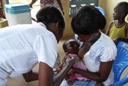 Volunteer Medicine & Healthcare A qualified nurse assists with caring for a sick baby at a local clinic at our volunteer placement in Ghana.