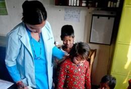 Volunteer Medicine & Healthcare A qualified nurse volunteering in Nepal performs a healthcare screening check on local children in a hospital in Chitwan.