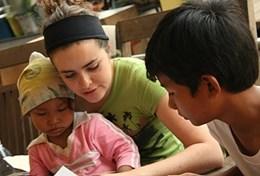 Volunteer Cambodia A professional occupational therapy volunteer works through a treatment regime with local children in Cambodia.