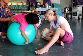 Volunteer Medicine & Healthcare A qualified Occupational Therapist works on a mobility exercise with a disabled child at our volunteer placement in Samoa.