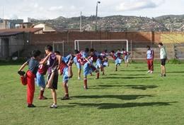 Volunteer Teaching A professional physical education teacher leads school children through a stretching class at his volunteer placement in Peru.