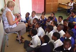 Volunteer Teaching A professional teacher works with a class of school students at her volunteer placement in South Africa.