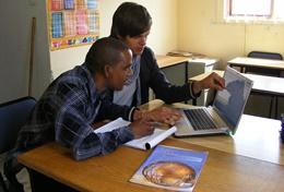 Volunteer Business A professional Business volunteer goes through the business plan of a local entrepreneur at one of our volunteer placements.