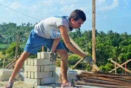 Volunteer Building A High School Special volunteer helps with building the framework for a house in the Philippines.