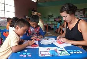 Volunteer Care A high school student volunteering in Ecuador runs an art class with children from a local care centre, teaching them new skills in a creative way.