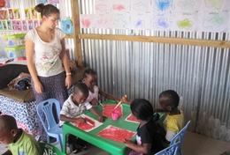 Volunteer Care A High School Special volunteer holds an art class to teach children at a daycare centre in South Africa how to paint.