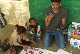 Volunteer Care A Care & Community volunteer has fun painting with local children in Madagascar over his high school vacation.