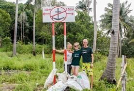 Volunteer Cambodia High School Special Conservation & Community volunteers stand in front of the rubbish they collected during a beach clean-up in Cambodia.