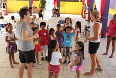 Volunteer Belize Public Health volunteers work together during a community outreach with local children in Belize.